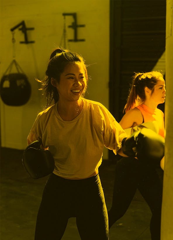 Women training on punch bags